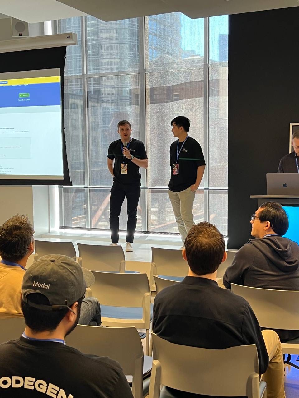 John Wilkie presenting Infinite Bazaar on stage at the AWS Builder Loft in San Francisco